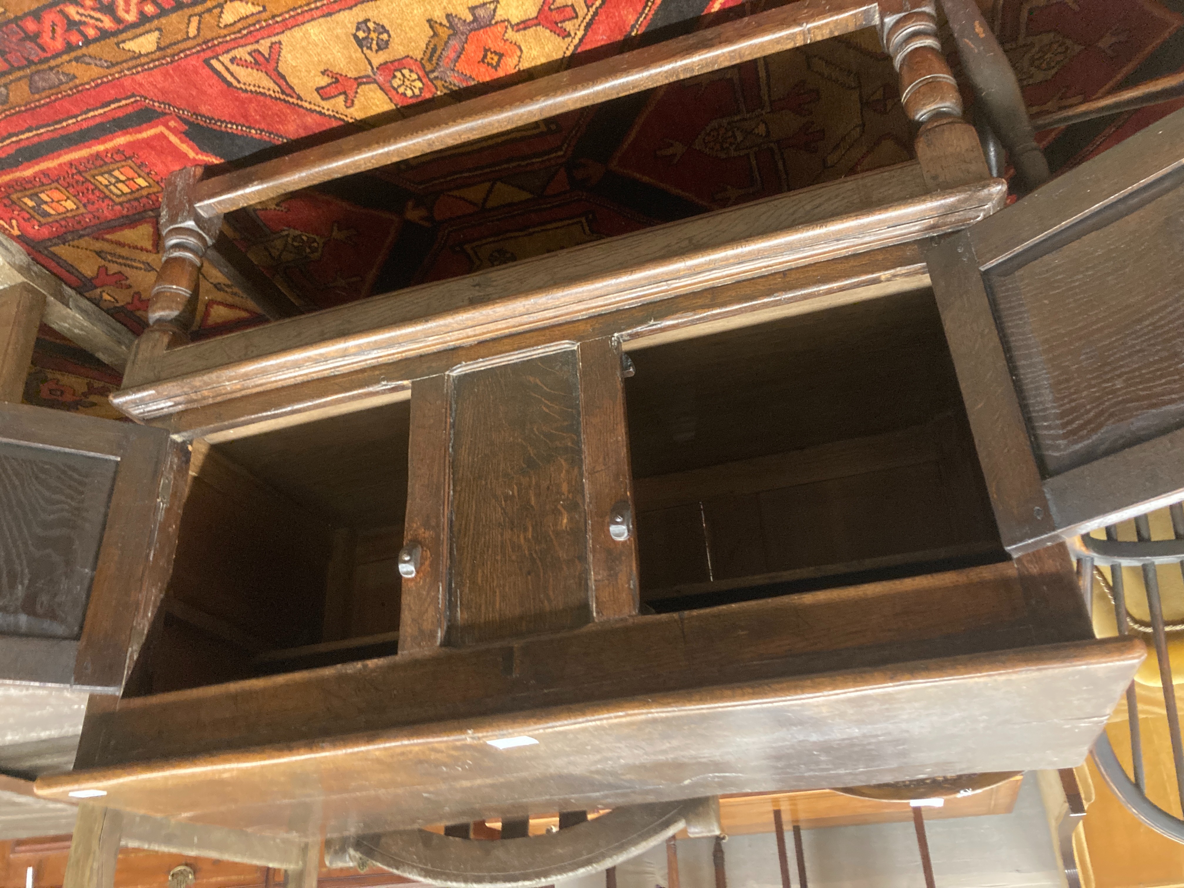 A Tudor style oak two door cupboard, enclosed by two doors, width 108cm, depth 50cm, height 88cm